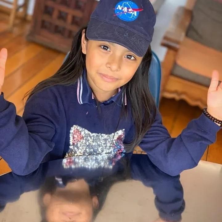 Ahara posing in her nasa baseball cap