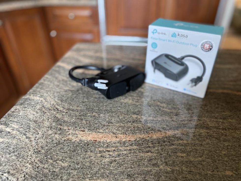 TP-Link Kasa Smart Wi-Fi Outdoor Plug on a counter unboxed