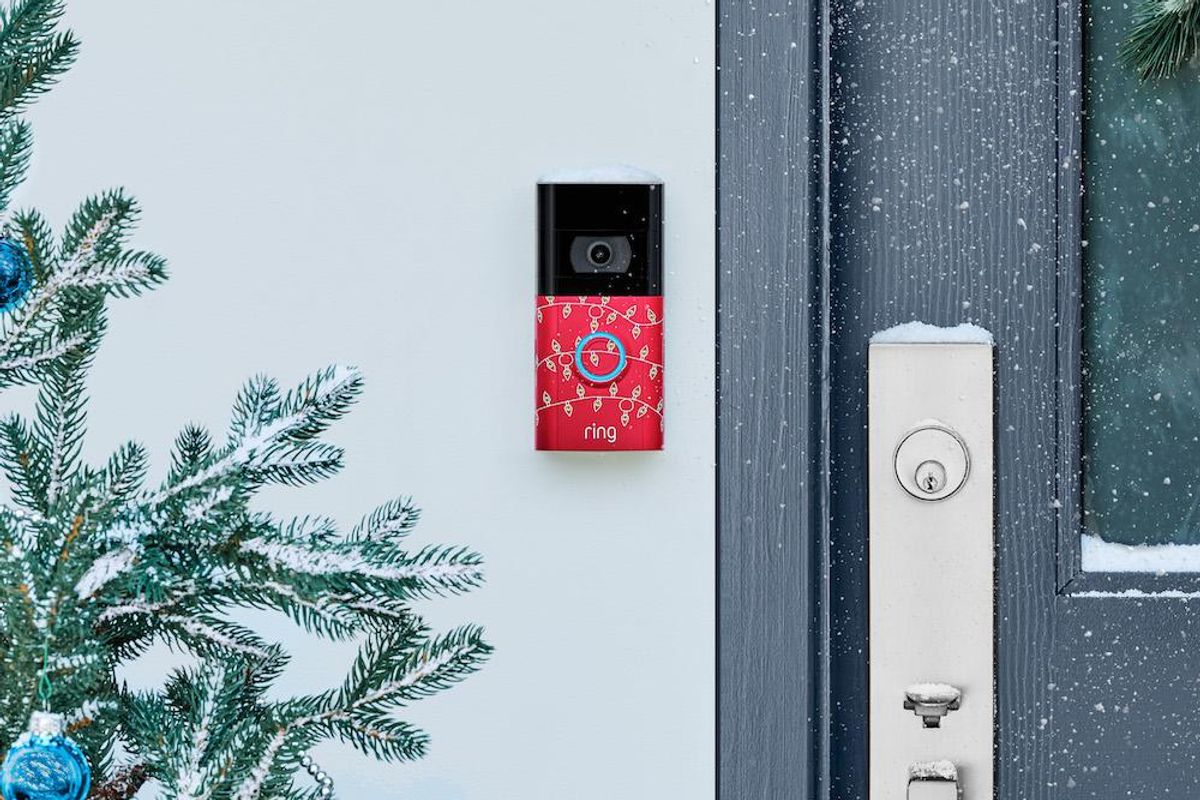 Ring Video Doorbell installed with holiday decorations and snow.