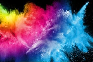 An explosion of paint colors against a black background from left to right: a bit of green, then yellow, a lot of pink, and then a sky blue at the right