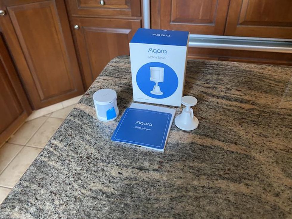 Aqara Motion Sensor unboxed on a countertop