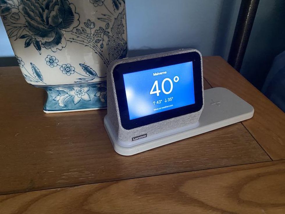 Lenovo Smart Clock 2 on a nightstand showiing the current weather outside on its display