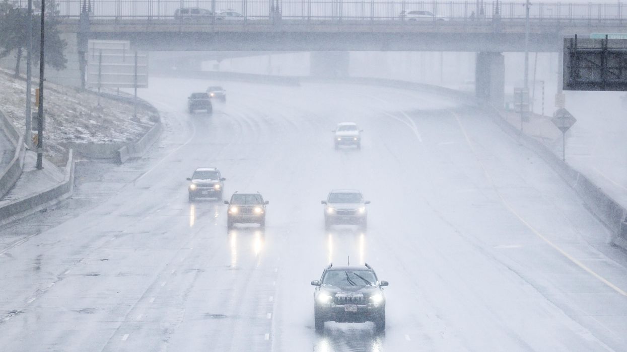 Cars drive through snow