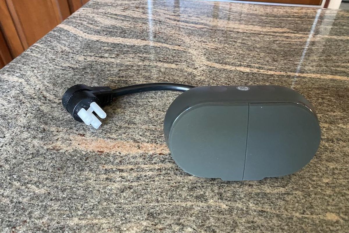 Cync Outdoor Smart Plug on a countertop unboxed.