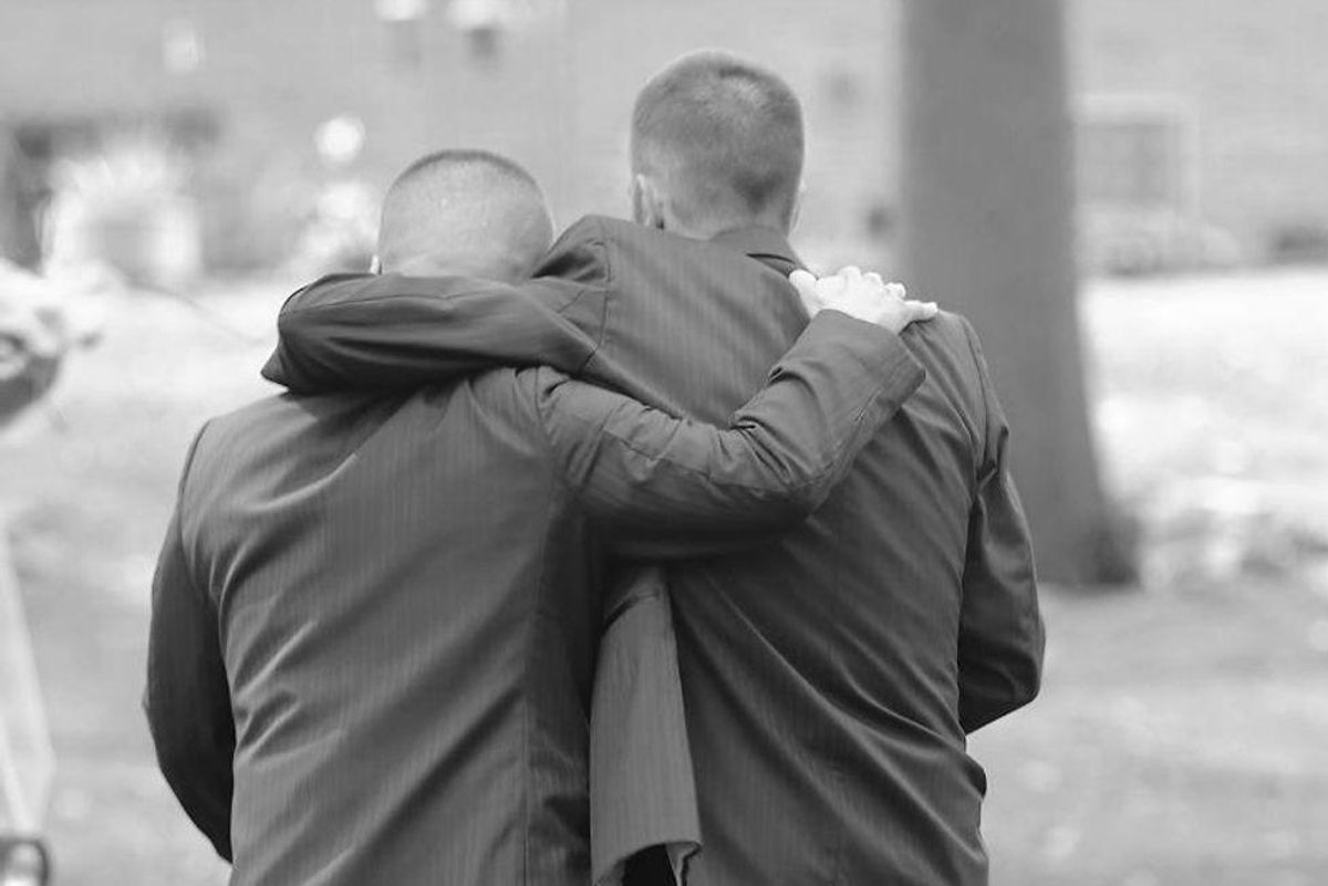 two men with their arms around each other's shoulders