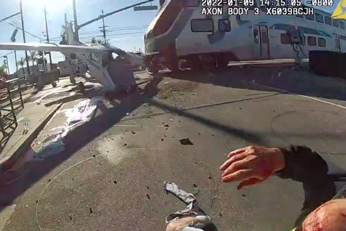 Officers pull man from his crashed airplane mere seconds before a train barrels into it