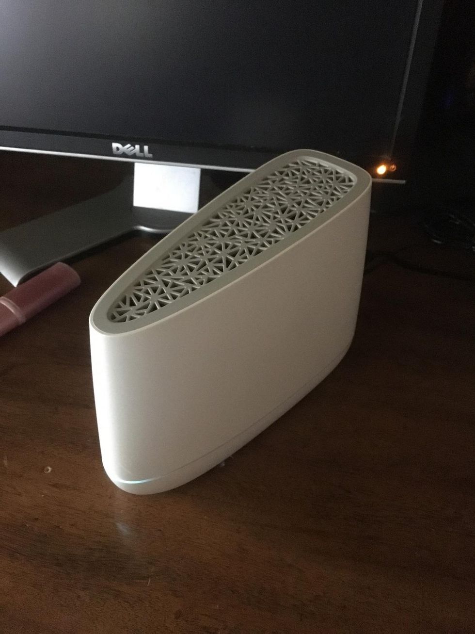 A photo of VIVINT SMART DRIVE PLAYBACK DVR on a desk inside a home connected to a home router.