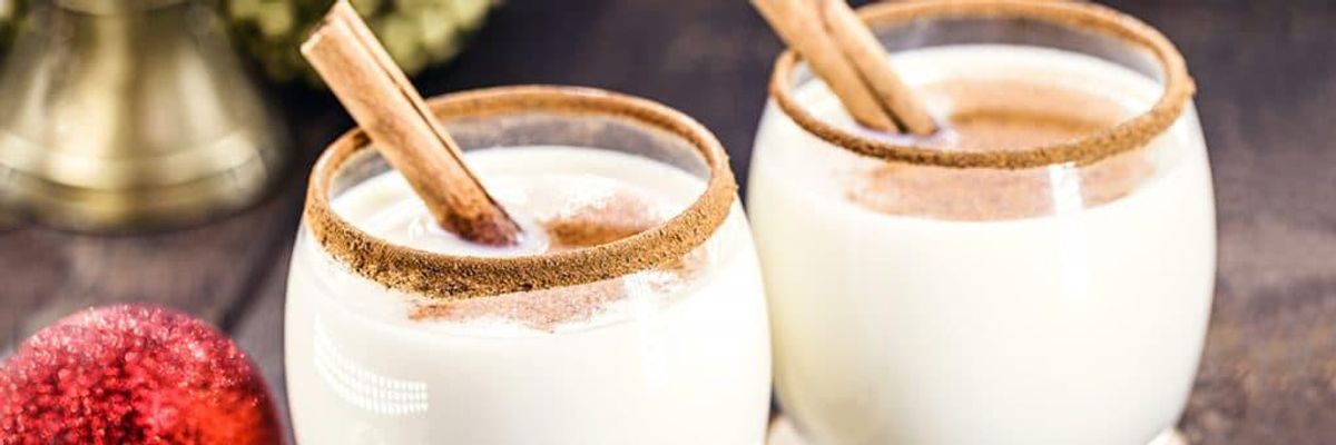 two glasses of coquito rimmed with cinnamon 