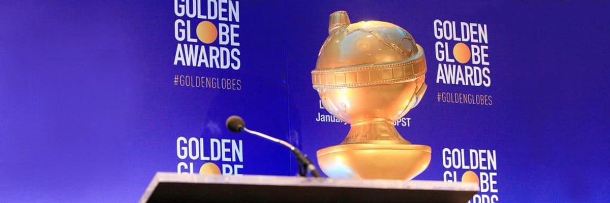 golden globe award in front of backdrop