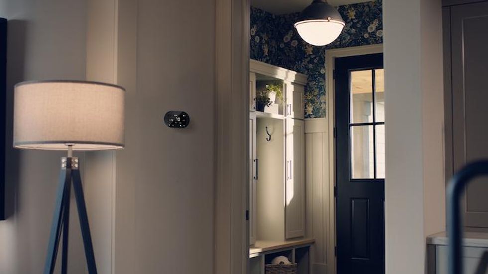 Cync smart thermostat on a wall in an entryway