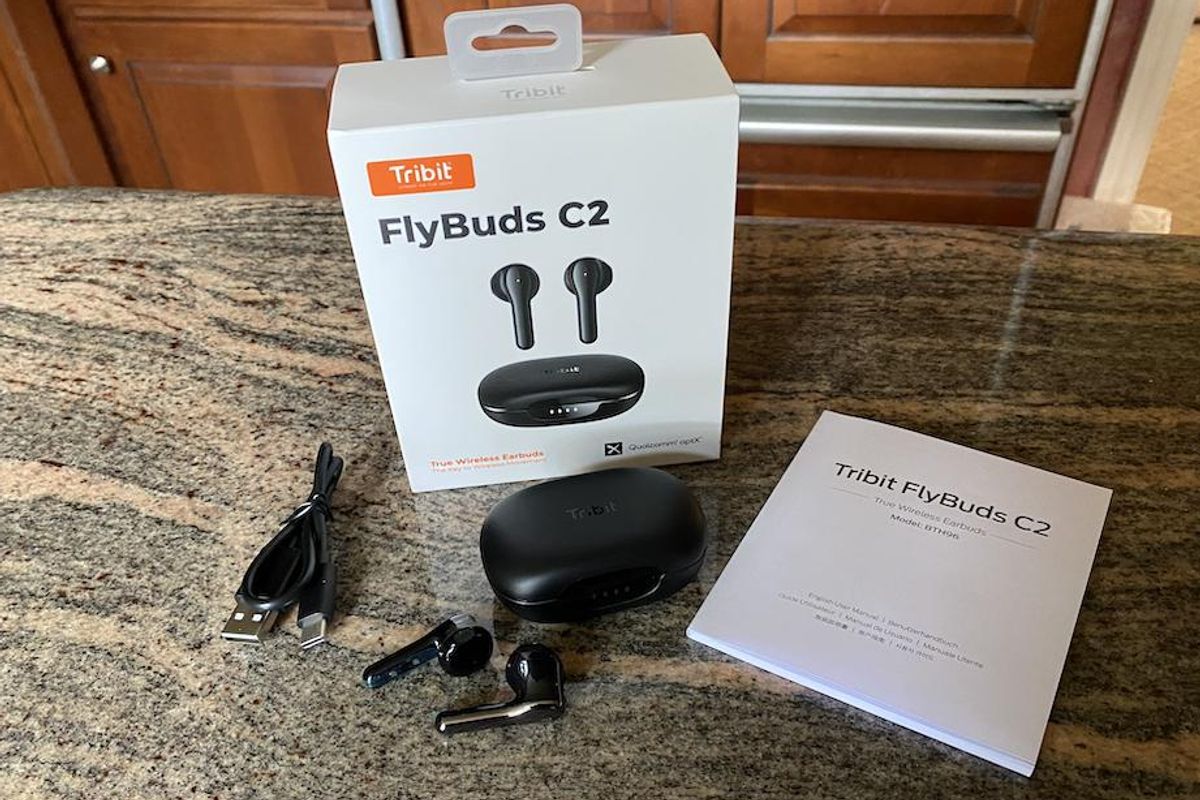 Tribit FlyBuds C2 wireless earbuds unboxed on a countertop