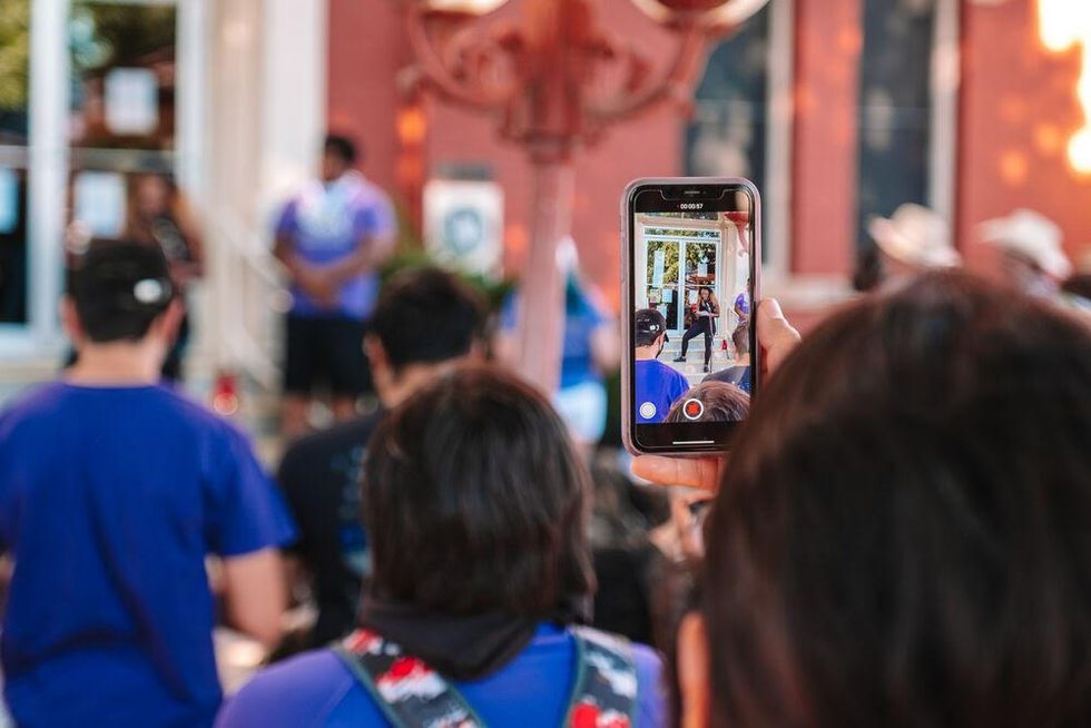 person recording speakers on their phone