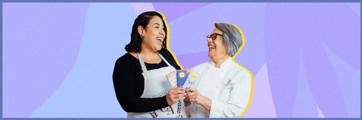 two women holding chocolate bars