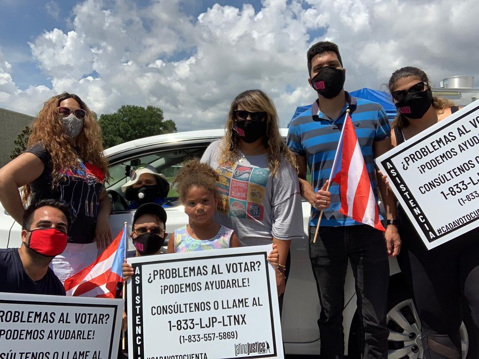 Group photo with people holding Latino justice signs.