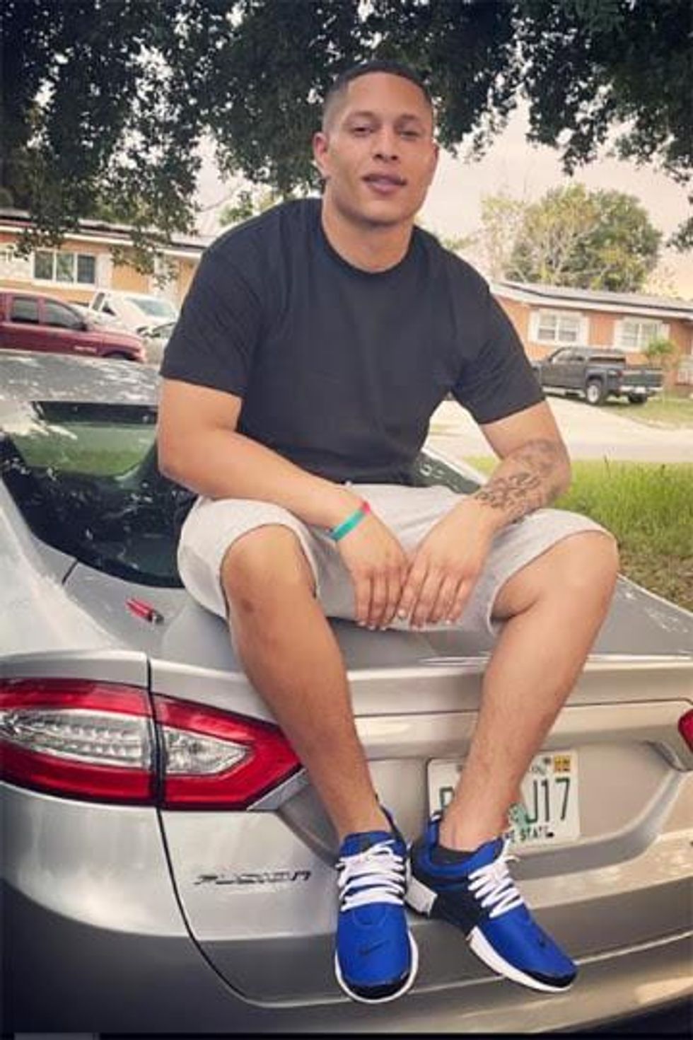 Armando Manuel Caballero sitting on a car