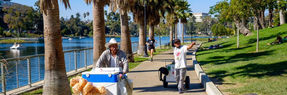 Two street vendors walk on the streets in LA