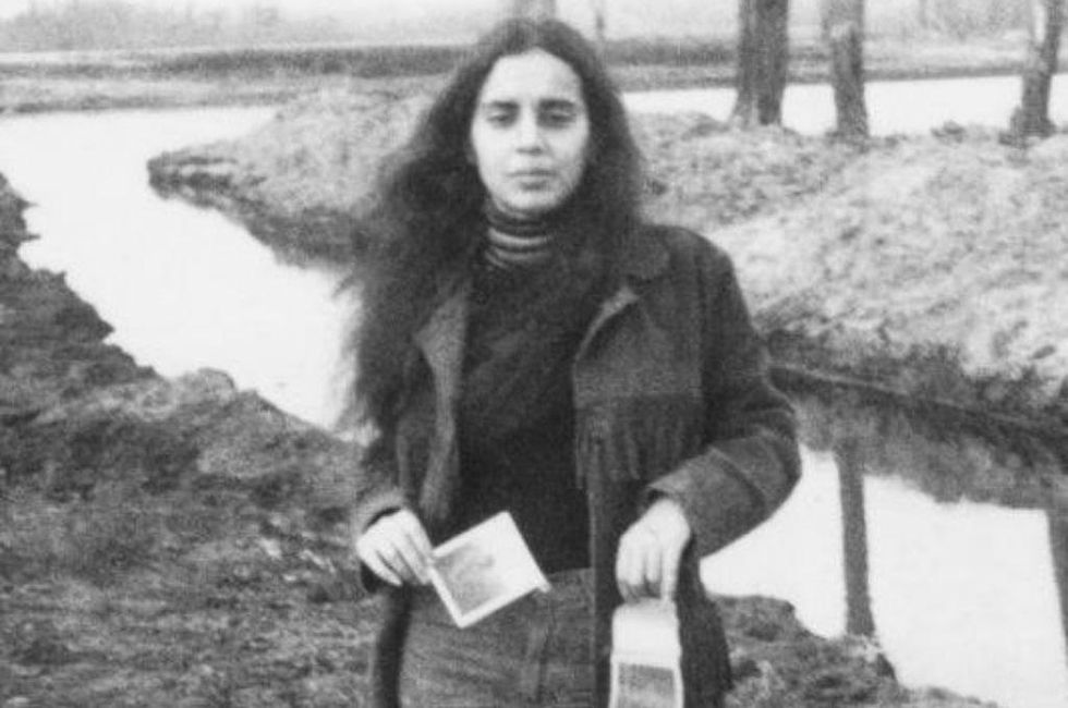 Ana Mendieta holding photos