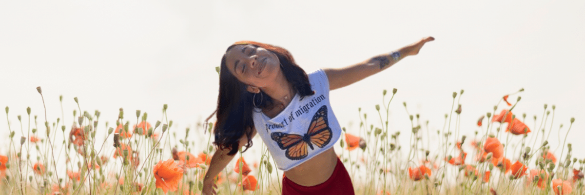 woman, Kim Guerra, playing in flower garden