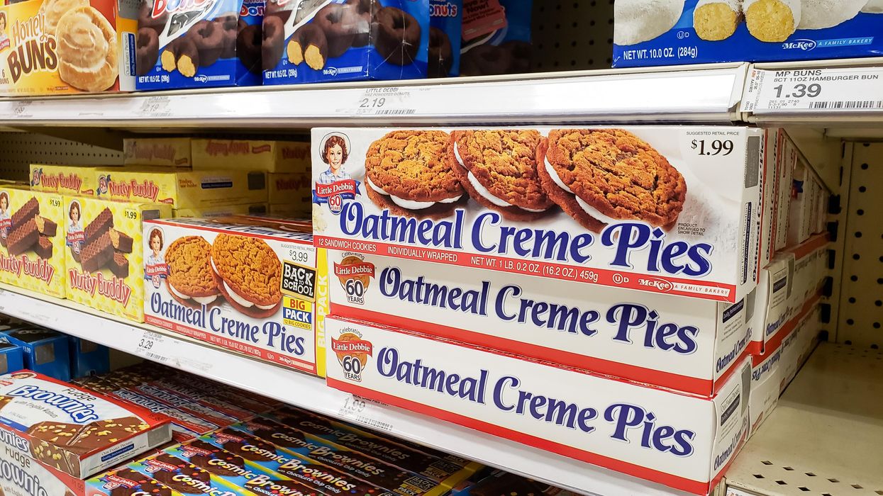 A grocery store shelf stocked with Oatmela Creme Pies, Nutty Buddy, Cosmic Brownies