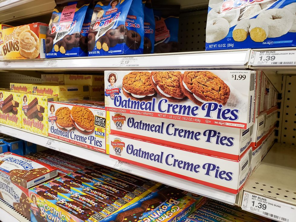 A grocery store shelf stocked with Oatmela Creme Pies, Nutty Buddy, Cosmic Brownies