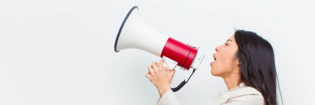 Woman yelling into a megaphone.