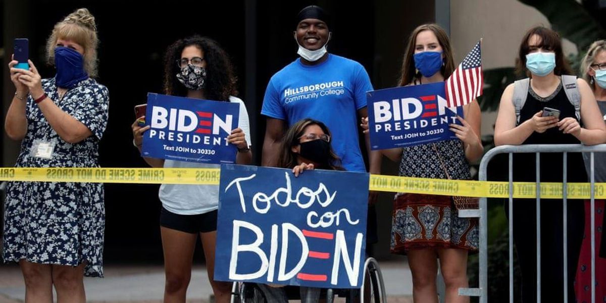 Group of people with signs that say "Biden for President".