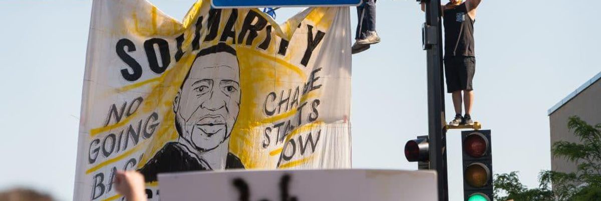 Banner of George Floyd hung on a street light.