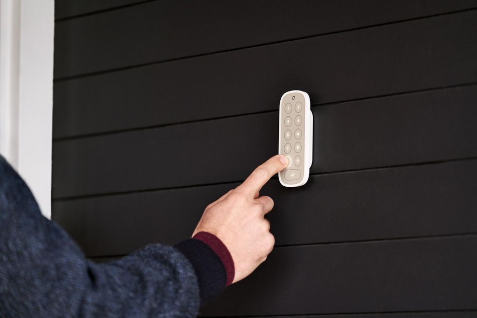 Level Keypad on the side of a house next to the front door.