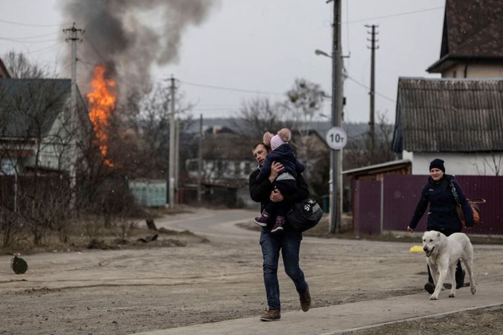Residents Fleeing Town Near Kyiv Caught In Shelling, Family Killed