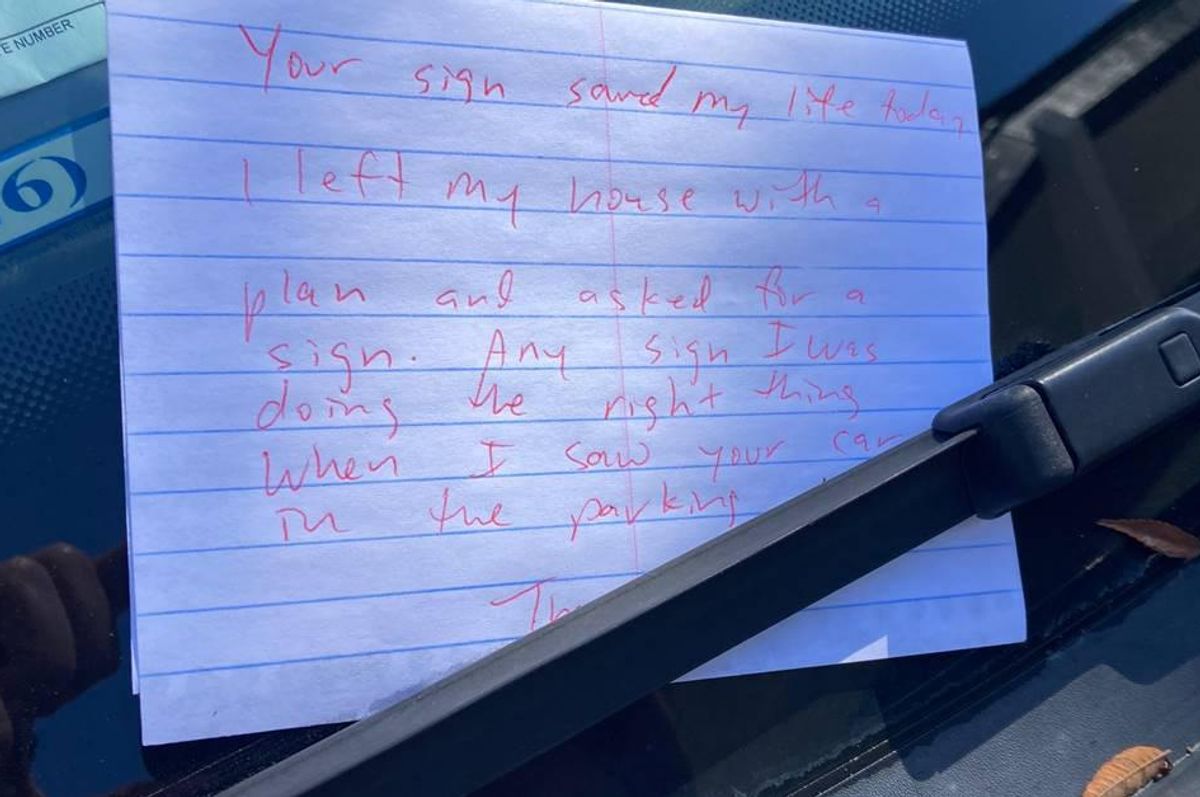 note tucked under a windshield wiper