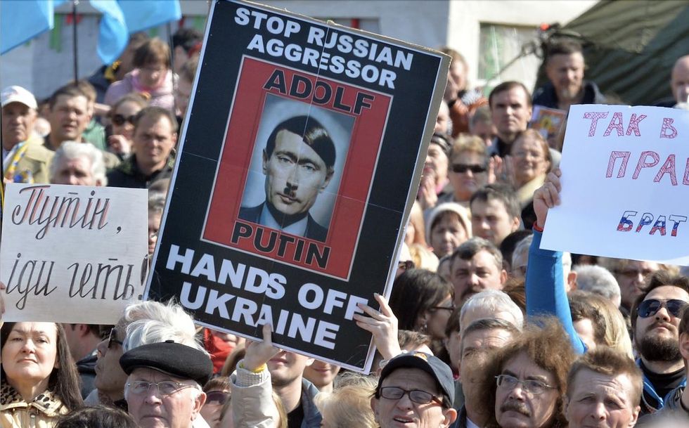 'Adolf Putin': Images of Russian president looking like Adolf Hitler pop up as protests against invasion of Ukraine quickly spread