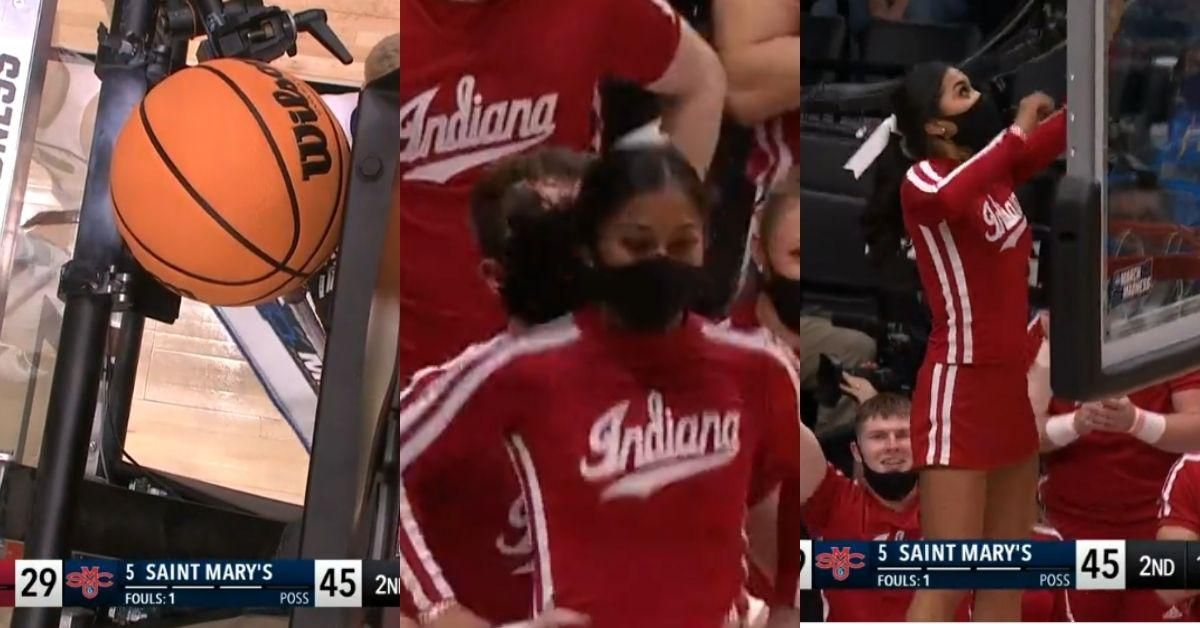 Indiana Cheerleader Saves The Day After Basketball Gets Stuck Behind Backboard During Game