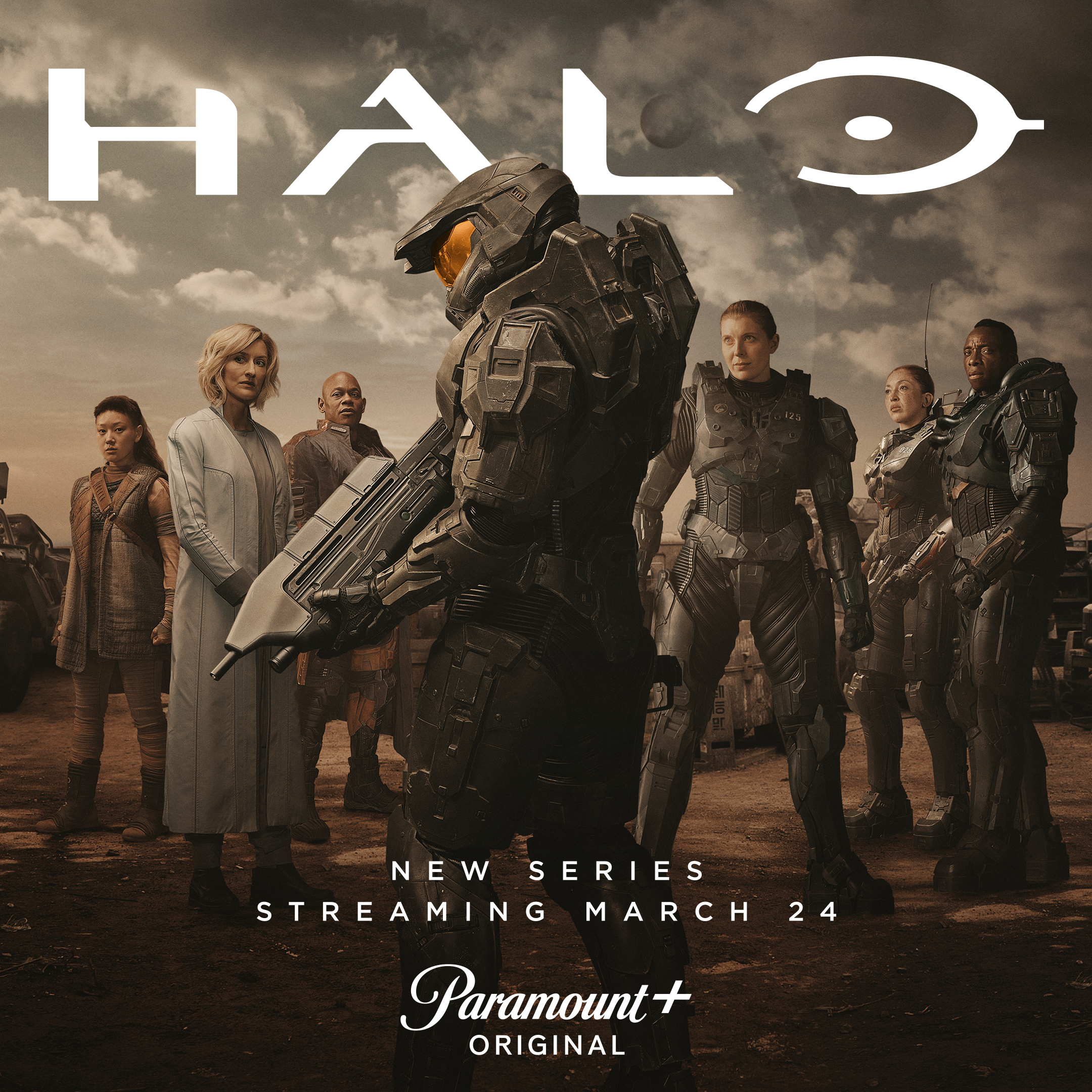 A promotional poster for Halo Season 1 shows Pablo Schreiber as Master Chief in uniform holding an MA5C assault rifle and surrounded by fellow cast members.