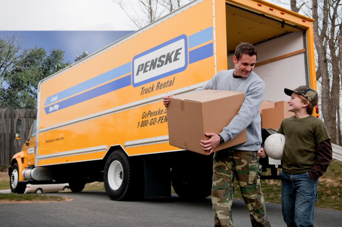 Military father and son unloading a Penske truck from a recent move.