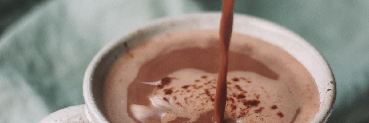 chocolate pouring in white mug