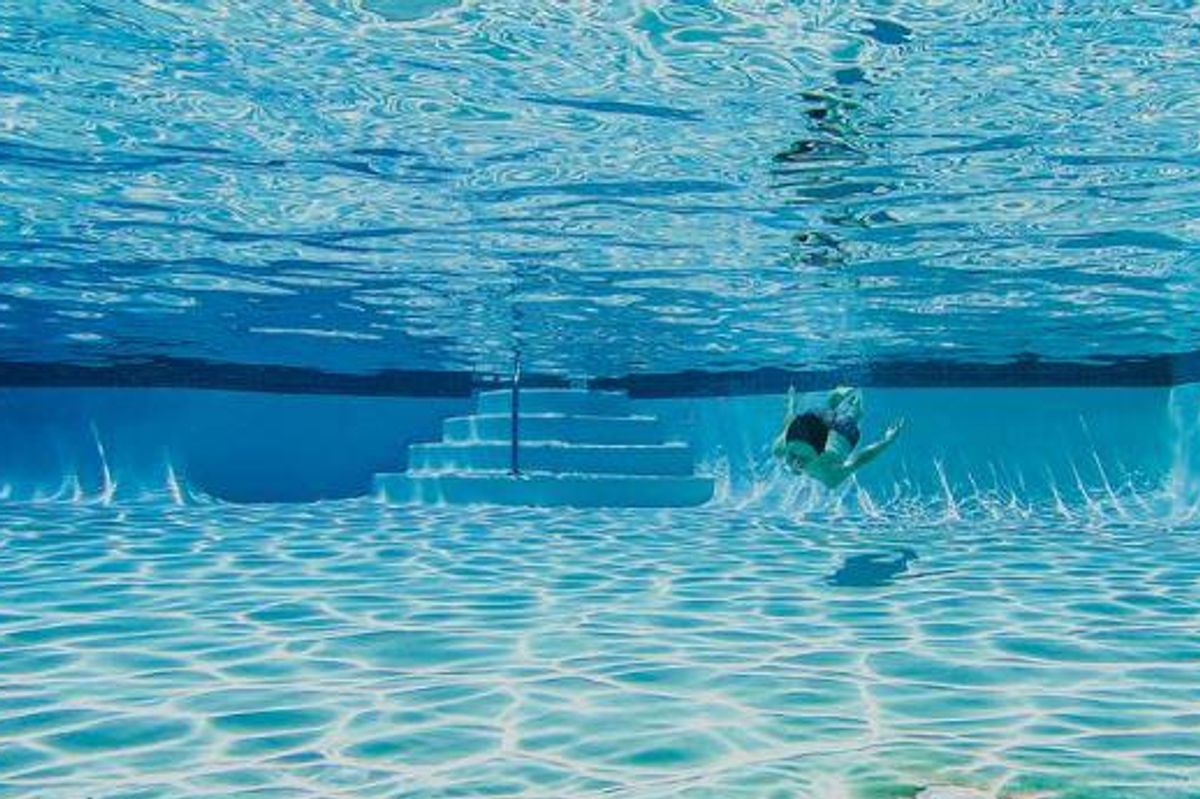A child swimming in a residential pool.