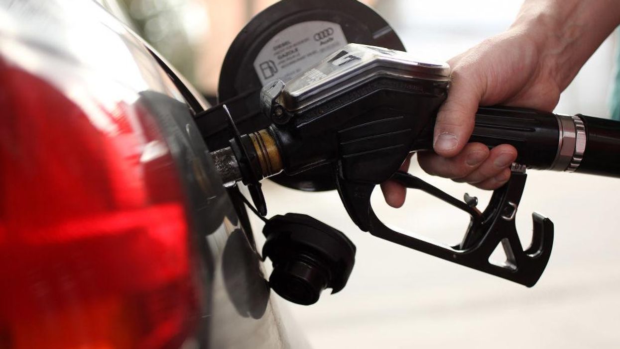 Someone pumping gas at a gas station