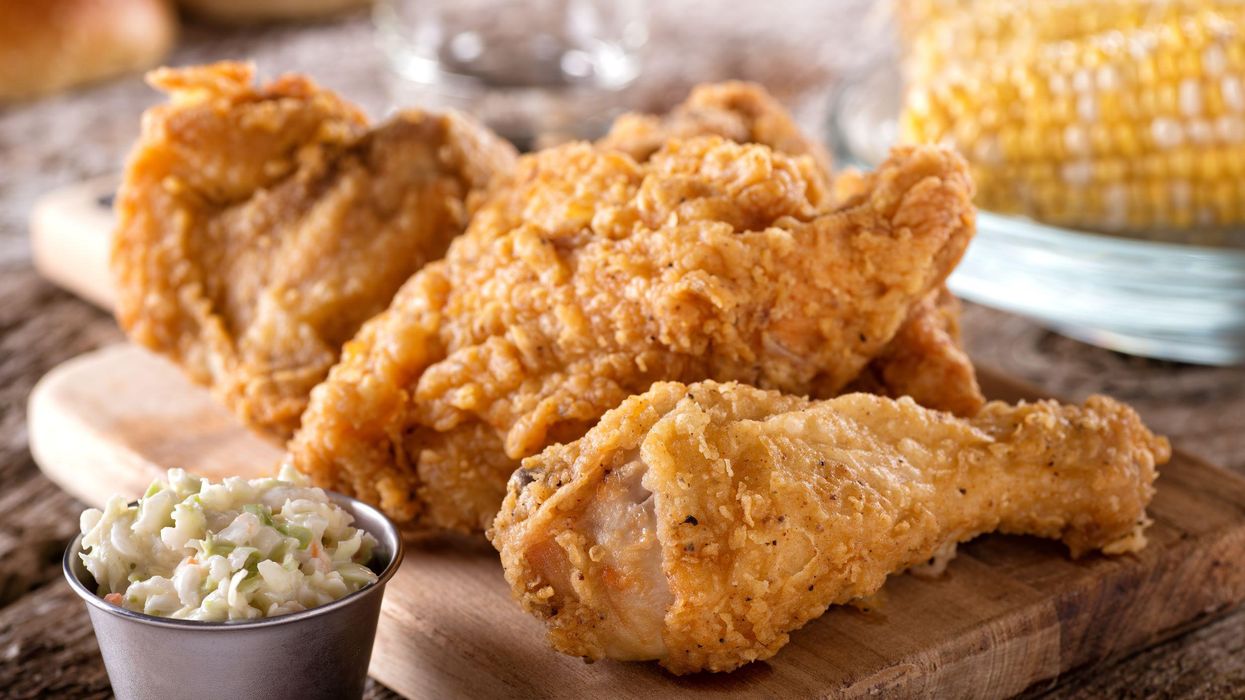 Fried chicken on a cutting board with a side of slaw