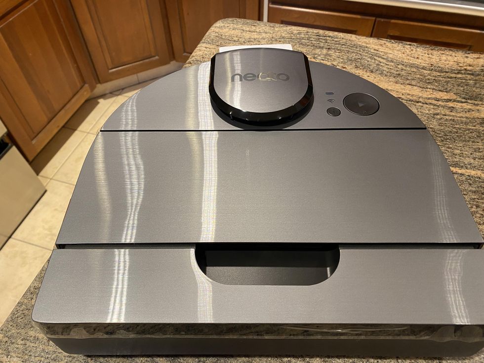 Photo of Neato D10 robot vacuum on a countertop