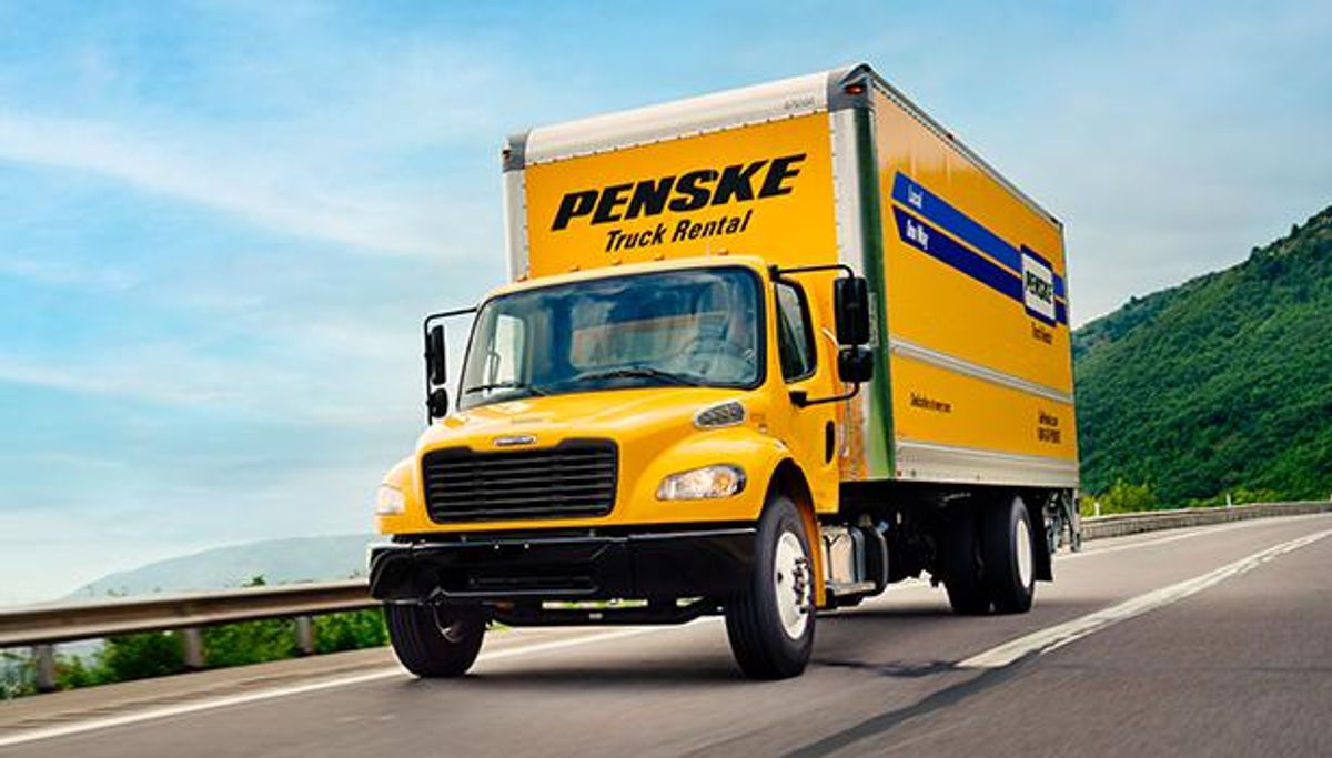 A Penske truck driving on the road
