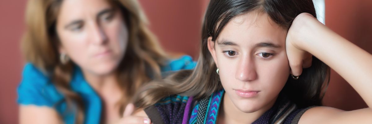 Woman looking at a young girl with concern