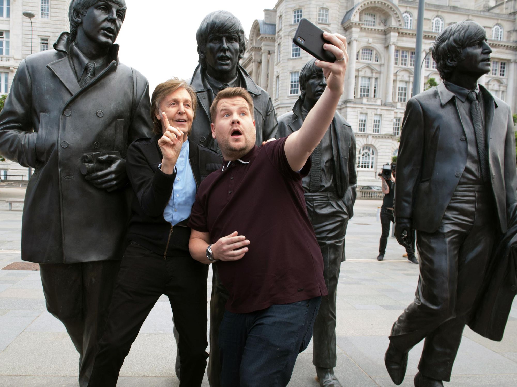 ​Paul McCartney and James Corden posing for a selfie in London in front of a Beatles statue