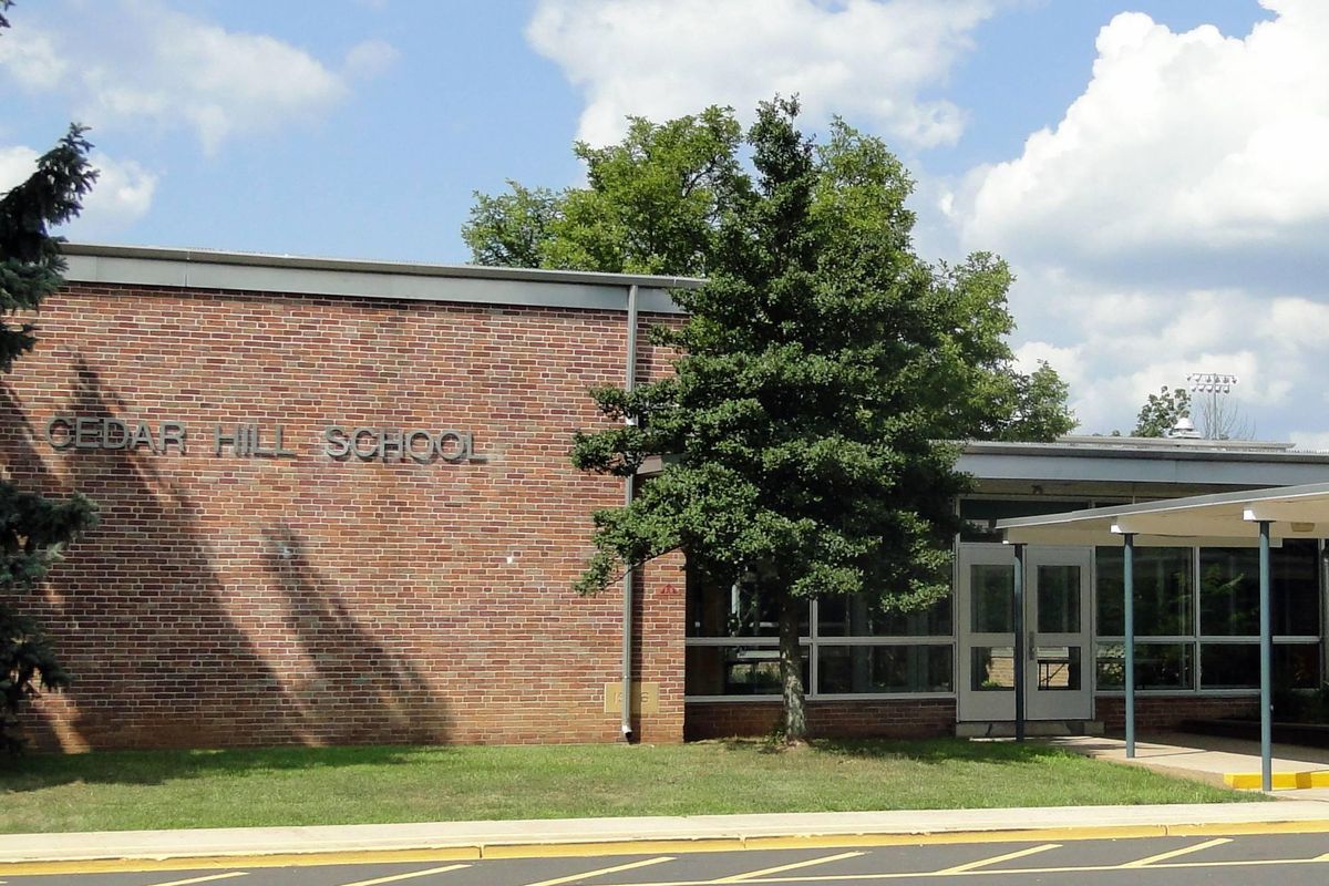 brick building with "Cedar Hill School" written on the side