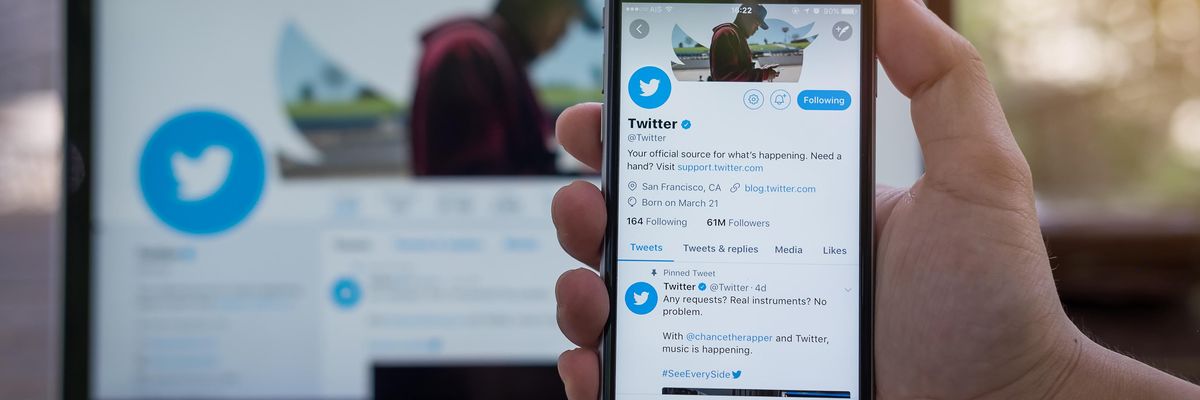 Image on the twitter app open on a phone and a computer