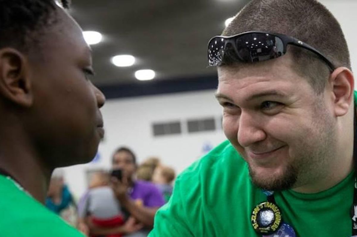 A teacher smiles at a student