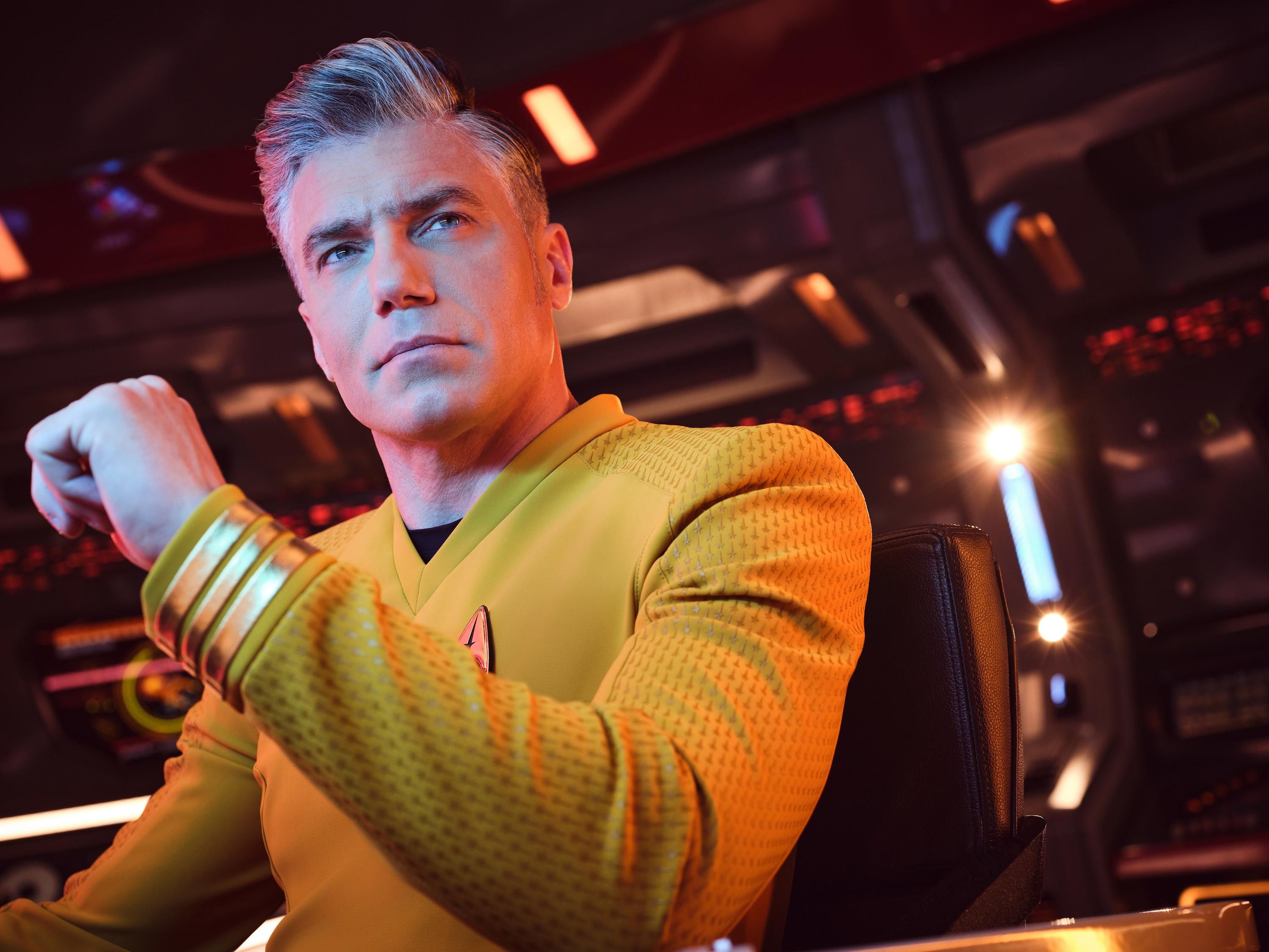 Pike in his yellow Star Trek uniform looking distinguished