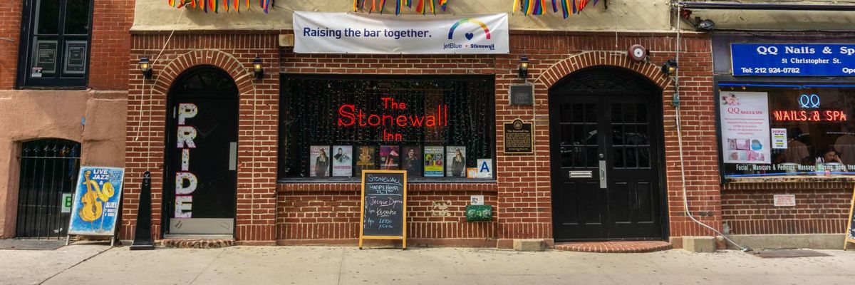 picture of the front entrance of the Stonewall Inn, adorned with rainbow pride flags