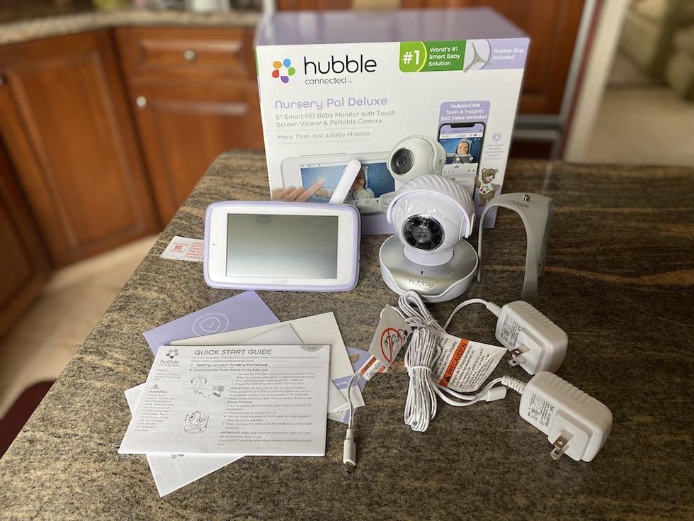 a photo of Hubble Connected Nursery Pal Deluxe Smart Baby Monitor system unboxed on a countertop