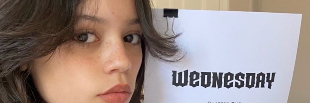 Jenna Ortega posing with the script for her role as Wednesday Addams in new netflix show 