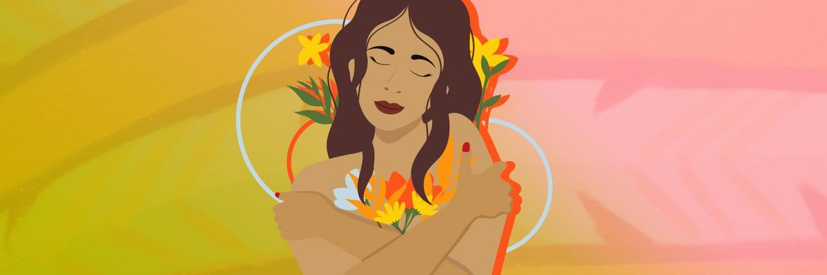 woman hugging herself with flowers surrounding her